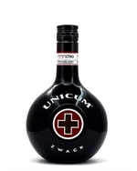 Rund mørkegrøn flaske Unicum med rødt kors på etiketten